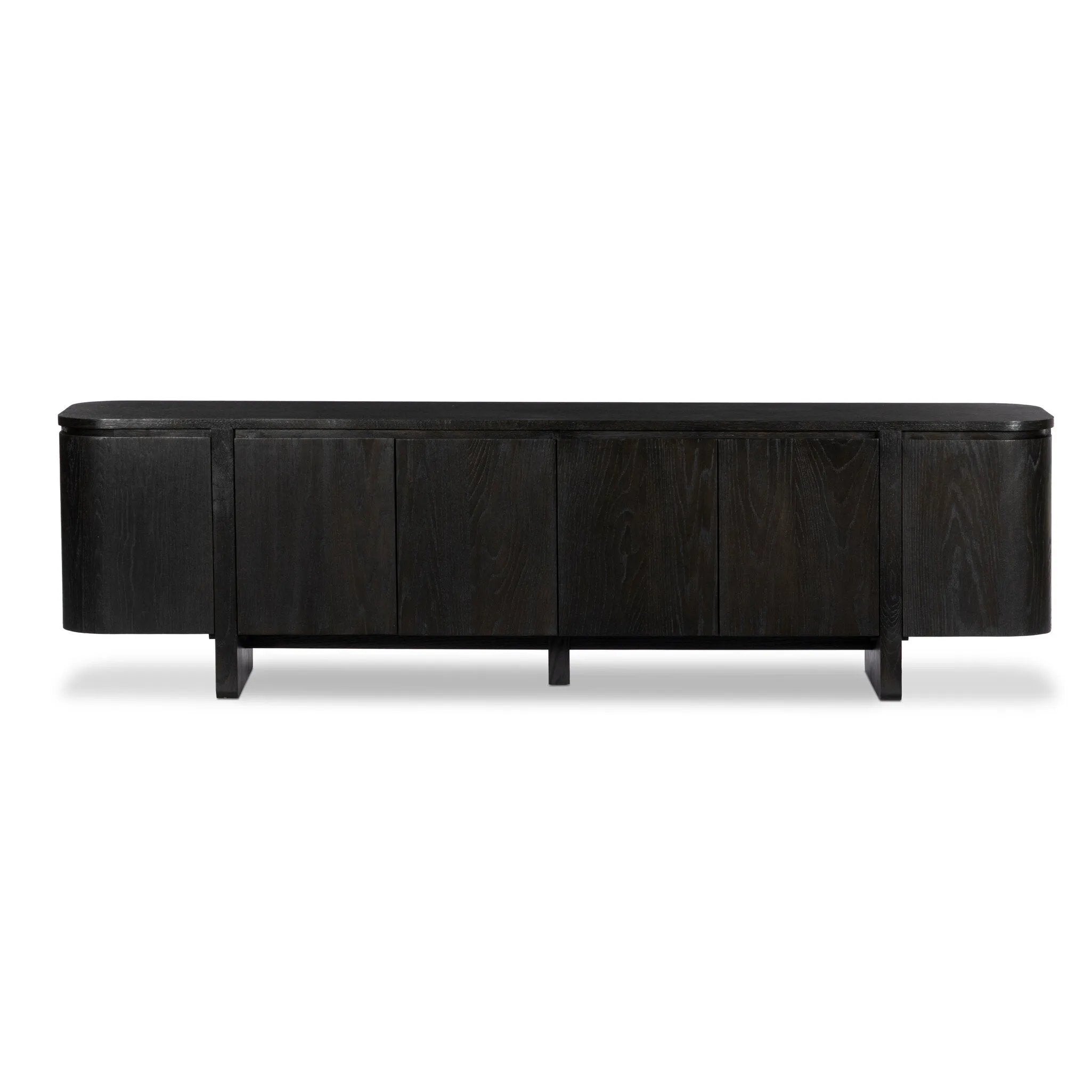 A clean-styled media console made from worn black oak. Six doors feature subtle finger grooves for easy open. Gentle curves soften up the look, while a floating design keeps things feeling light and fresh. Inside, generous shelving awaits storage of media and more. Amethyst Home provides interior design, new home construction design consulting, vintage area rugs, and lighting in the Salt Lake City metro area.