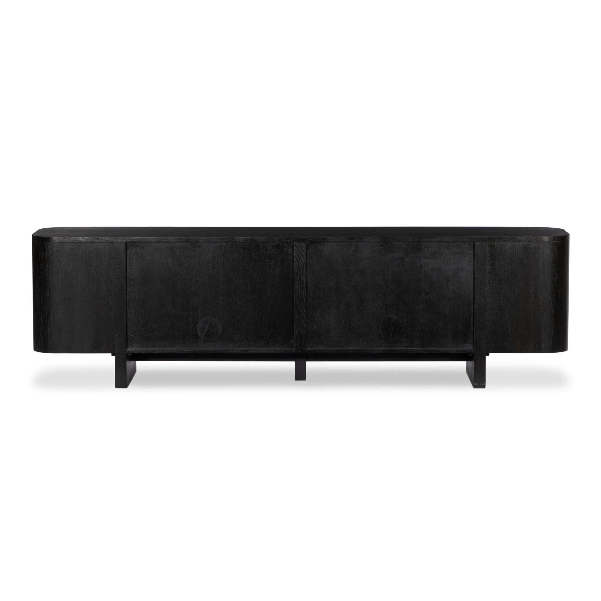 A clean-styled media console made from worn black oak. Six doors feature subtle finger grooves for easy open. Gentle curves soften up the look, while a floating design keeps things feeling light and fresh. Inside, generous shelving awaits storage of media and more. Amethyst Home provides interior design, new home construction design consulting, vintage area rugs, and lighting in the Scottsdale metro area.