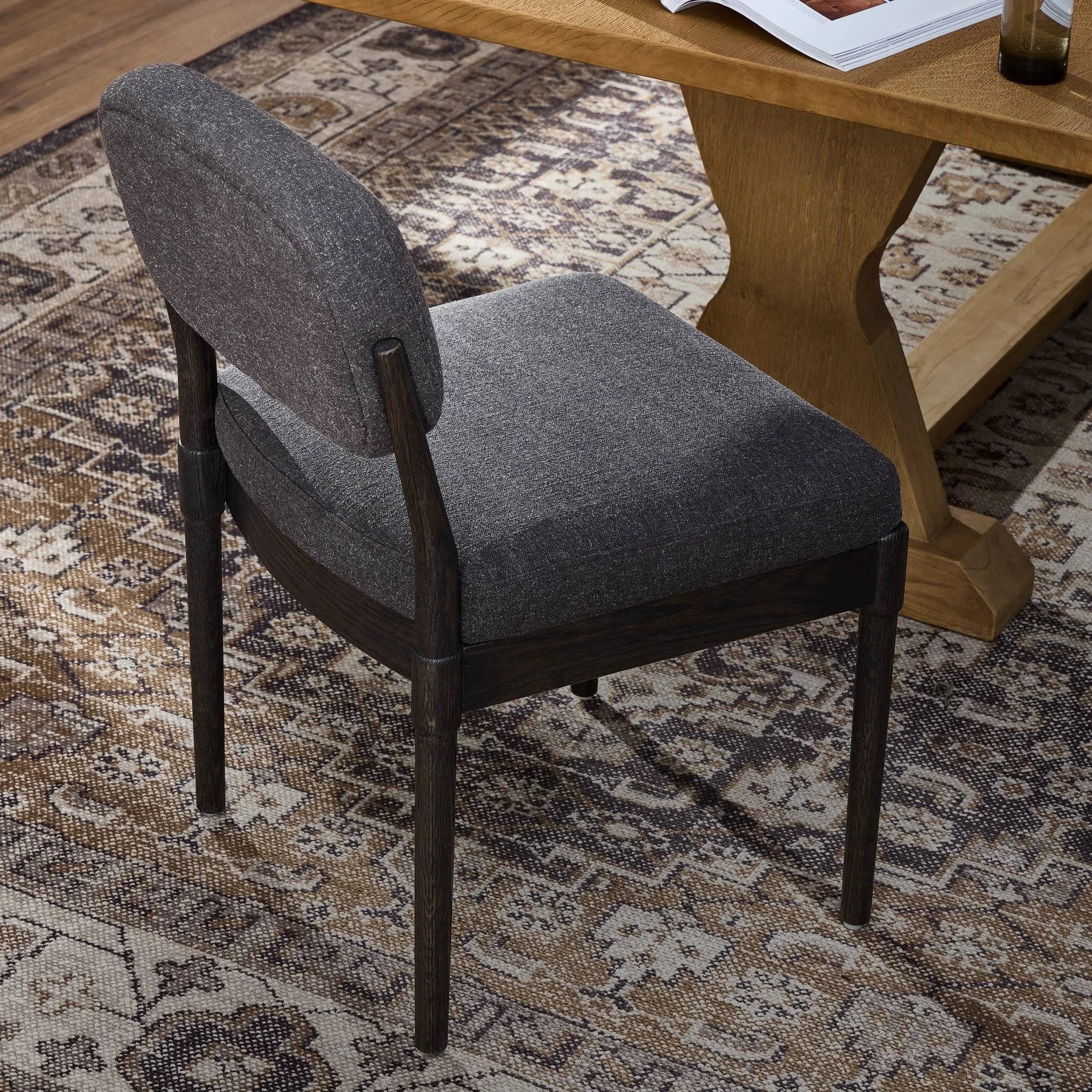 Modern materials place an updated twist on the traditional armless dining chair. Linen/cotton blend cushioning upholstered in high-performance fabric, perfect for everyday dining. Simply framed by burnt oak. Amethyst Home provides interior design, new home construction design consulting, vintage area rugs, and lighting in the San Diego metro area.