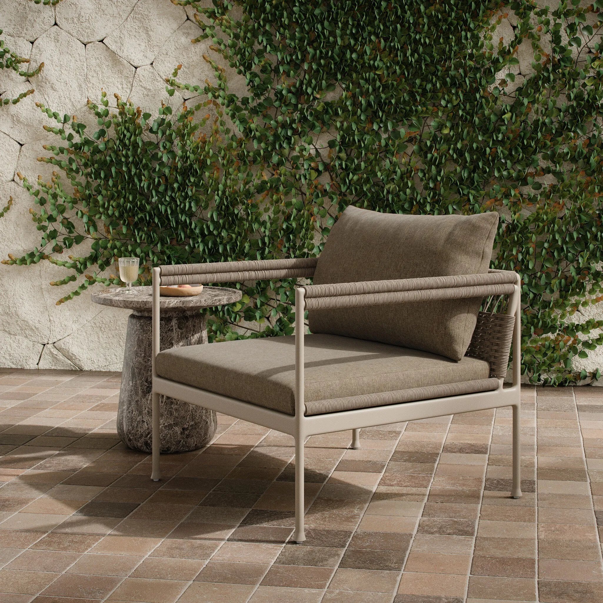 It's all in the mix with this outdoor chair, featuring a rich upholstery with a brushed texture, cord-wrapped arms and a woven back. The low-lying frame makes this the perfect seat for lounging. Cover or store inside during inclement weather and when not in use. Amethyst Home provides interior design, new home construction design consulting, vintage area rugs, and lighting in the Alpharetta metro area.