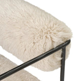 A textural take on a timeless silhouette. Hammered iron frames a squared seat and bolster back upholstered in off-white Mongolian fur Amethyst Home provides interior design, new home construction design consulting, vintage area rugs, and lighting in the Houston metro area.
