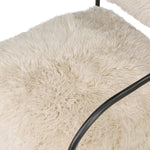 A textural take on a timeless silhouette. Hammered iron frames a squared seat and bolster back upholstered in off-white Mongolian fur Amethyst Home provides interior design, new home construction design consulting, vintage area rugs, and lighting in the Laguna Beach metro area.