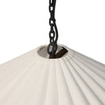 Textures and contrasting hues unite for this pendant's beautiful glow. The overscale scalloped shade features a creamy white canvas exterior covering a dark, antiqued brass interior, and a wrought iron chain for maximum drama Amethyst Home provides interior design, new home construction design consulting, vintage area rugs, and lighting in the Charlotte metro area.