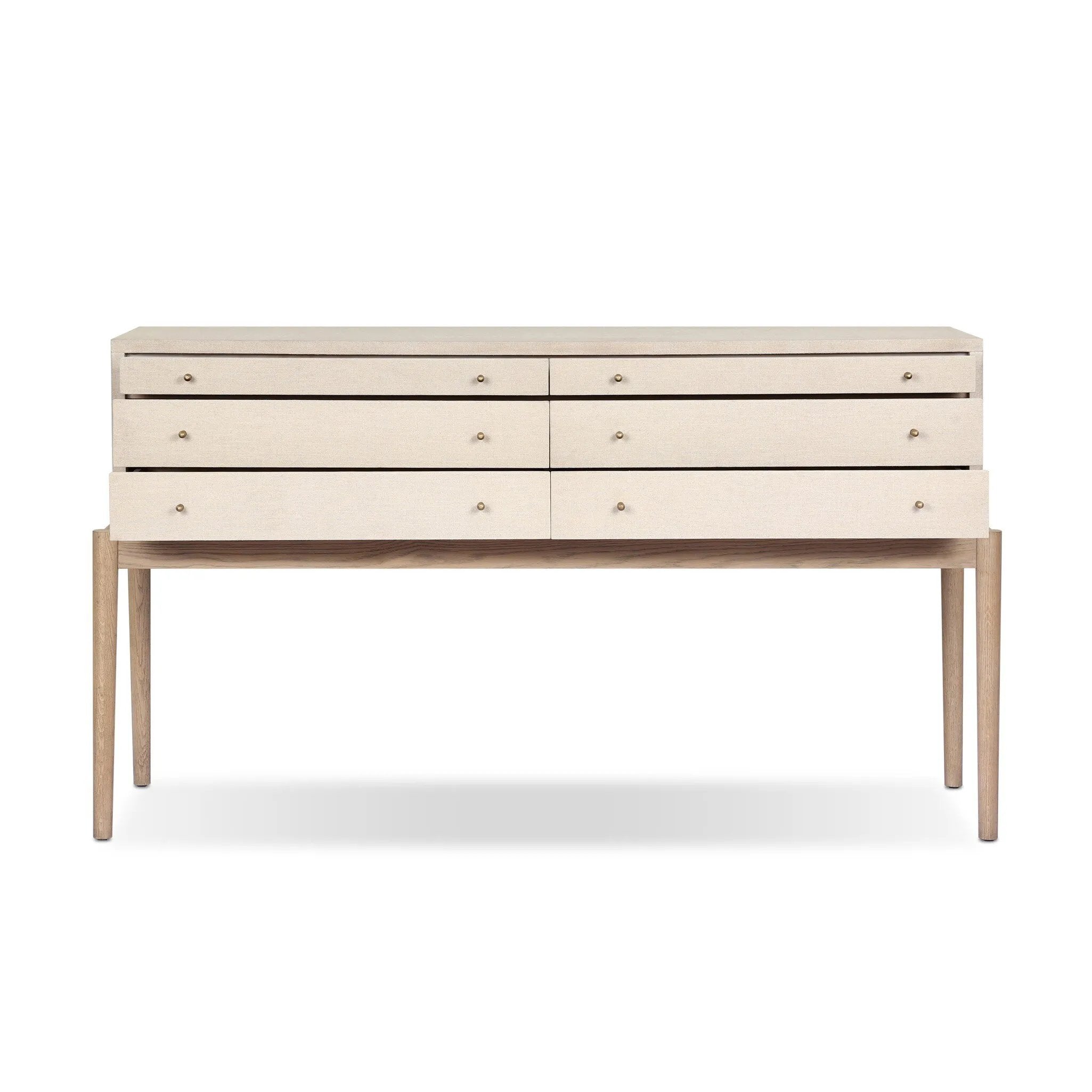 A soft statement console table with ample storage, inspired by a dresser silhouette. The elevated case is wrapped in painted linen and sits atop an oak base for a light and airy look Amethyst Home provides interior design, new home construction design consulting, vintage area rugs, and lighting in the Omaha metro area.