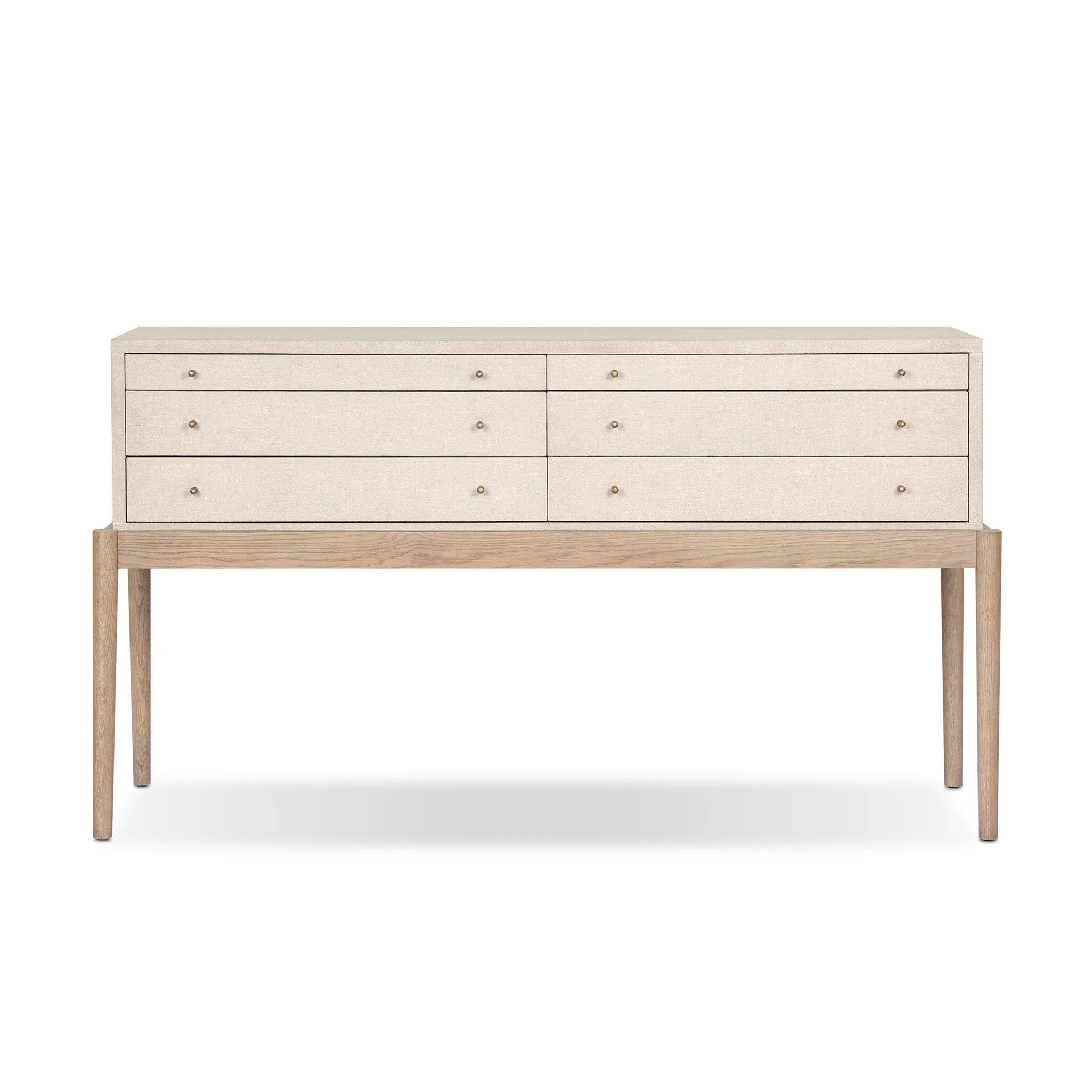 A soft statement console table with ample storage, inspired by a dresser silhouette. The elevated case is wrapped in painted linen and sits atop an oak base for a light and airy look Amethyst Home provides interior design, new home construction design consulting, vintage area rugs, and lighting in the Seattle metro area.