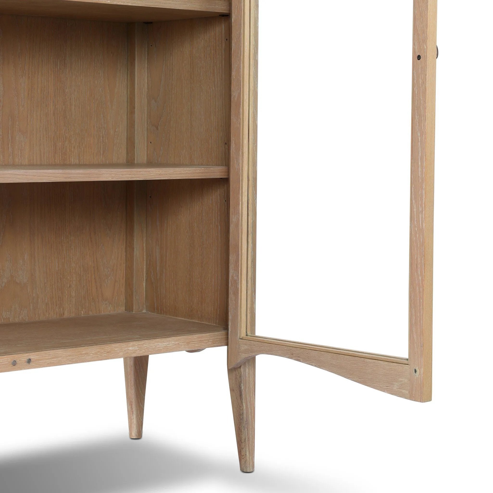Traditional design defines this light-finished oak cabinet. Simple, clean side panels highlight a softly curved bottom frame. Steel handles in a copper patina finish add a unique touch.As fans of wabi sabi design at Amethyst, we love the nature inspired Gates Cabinet - Light Natural Oak Veneer. Amethyst Home provides interior design, new home construction design consulting, vintage area rugs, and lighting in the Calabasas metro area.