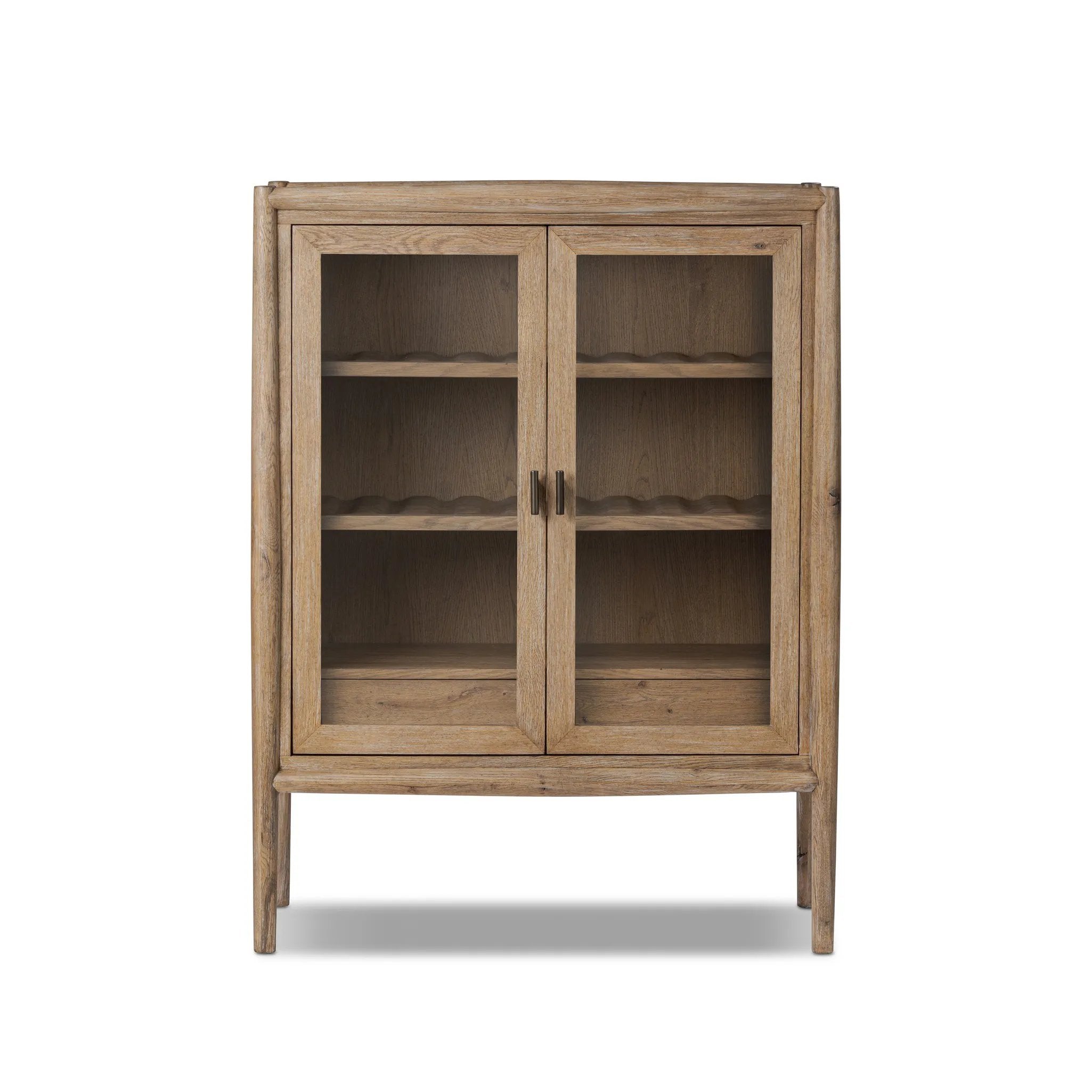A rustic oak bar cabinet shapes subtly curved corners, bringing a handcrafted look to a minimalist form. Fixed center shelves, functional drawers and glass fronts for open display. Simple hardware is finished in an aged bronze Amethyst Home provides interior design, new home construction design consulting, vintage area rugs, and lighting in the Miami metro area.