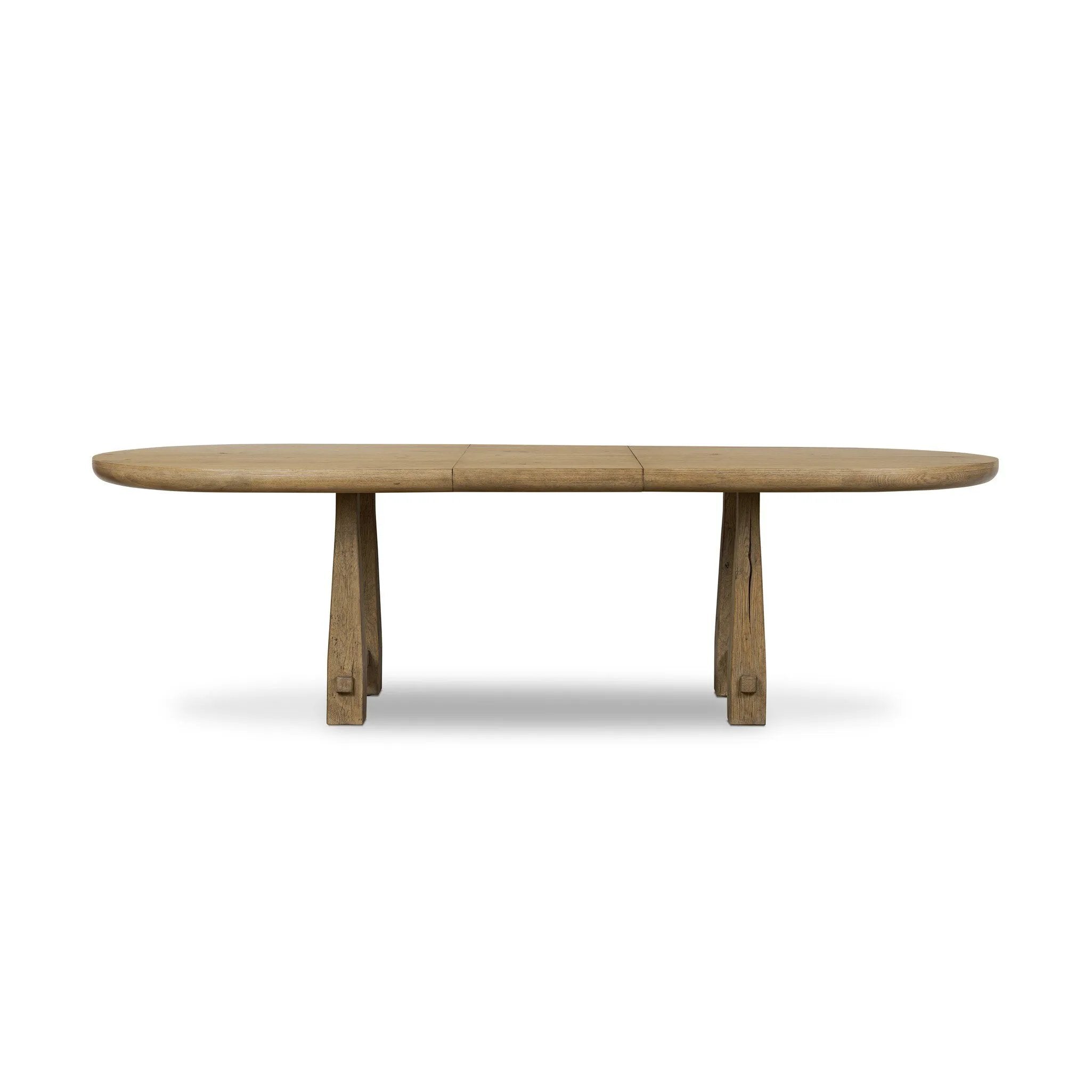 Make space to gather around. This extendable dining table is crafted from drifted oak veneer with a semi-trestle base, thick legs and an oval-shaped surface. The extension expands the table from 84" to a roomier 104" Amethyst Home provides interior design, new home construction design consulting, vintage area rugs, and lighting in the Charlotte metro area.