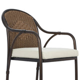 This outdoor dining chair takes inspiration from classic French bistro-style chairs, featuring a distinctive metal collar detail on the arms. The woven seatback comes together in a diamond pattern, finished with a cream-colored seat cushion. Cover or store inside during inclement weather and when not in use. Amethyst Home provides interior design, new home construction design consulting, vintage area rugs, and lighting in the Des Moines metro area.