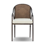 This outdoor dining chair takes inspiration from classic French bistro-style chairs, featuring a distinctive metal collar detail on the arms. The woven seatback comes together in a diamond pattern, finished with a cream-colored seat cushion. Cover or store inside during inclement weather and when not in use. Amethyst Home provides interior design, new home construction design consulting, vintage area rugs, and lighting in the Kansas City metro area.