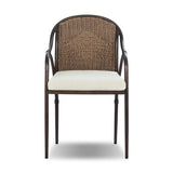 This outdoor dining chair takes inspiration from classic French bistro-style chairs, featuring a distinctive metal collar detail on the arms. The woven seatback comes together in a diamond pattern, finished with a cream-colored seat cushion. Cover or store inside during inclement weather and when not in use. Amethyst Home provides interior design, new home construction design consulting, vintage area rugs, and lighting in the Kansas City metro area.