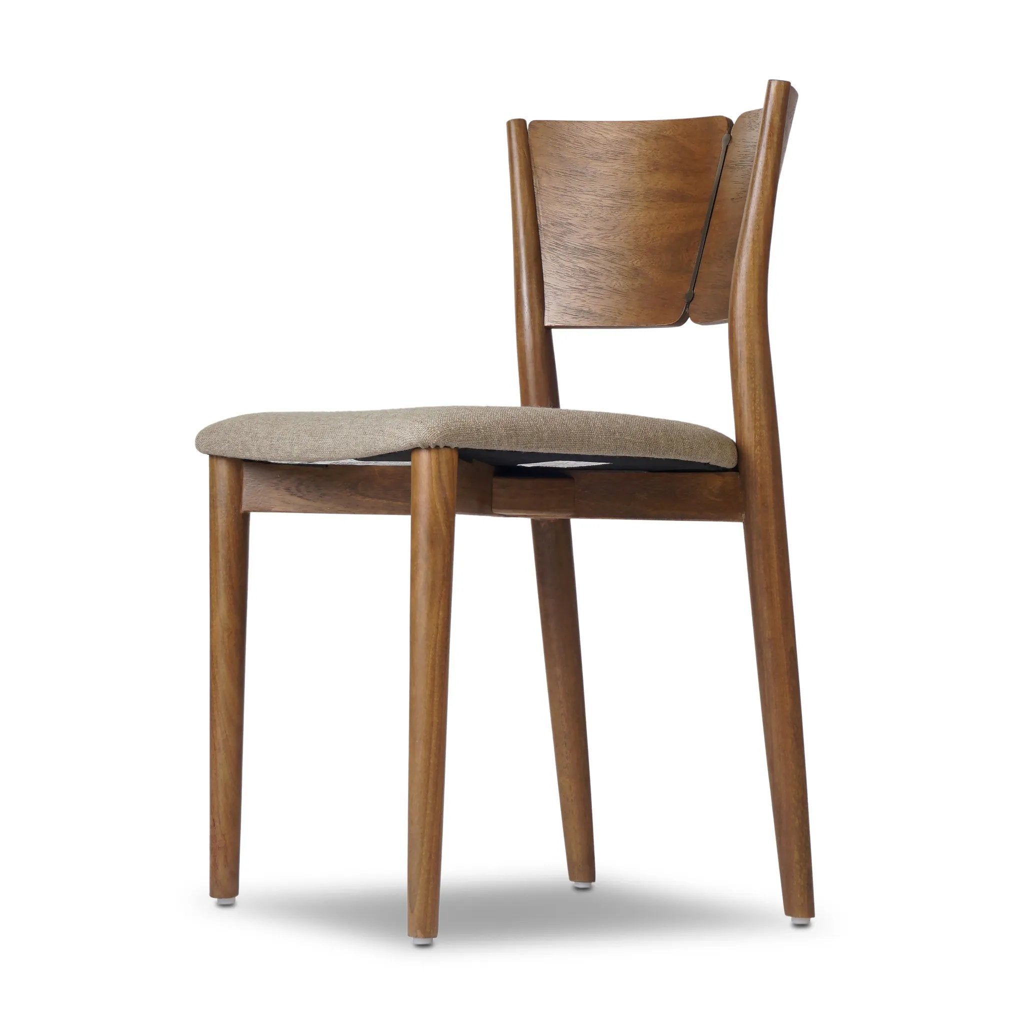 Bring a mixed material moment to your dining space with a Scandinavian-inspired seating style. Solid parawood forms a beautifully curved frame for a slim-profile seat upholstered in taupe high-performance fabric. On the back panel, a thin iron inlay elevates the look with a detail-driven finishing touch. Amethyst Home provides interior design, new home construction design consulting, vintage area rugs, and lighting in the Newport Beach metro area.
