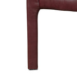 A bold dining chair design inspired by Italian modernism. Made from burgundy top-grain leather, with a wide format that contrasts slimmer chamfered legs leaving airiness underneath. The result: A beautiful balance of scale.As enthusiasts of luxe aesthetics at Amethyst, we love the warm modern inspired Graford Dining Chair - Dulane Burgundy. Amethyst Home provides interior design, new home construction design consulting, vintage area rugs, and lighting in the Austin metro area.