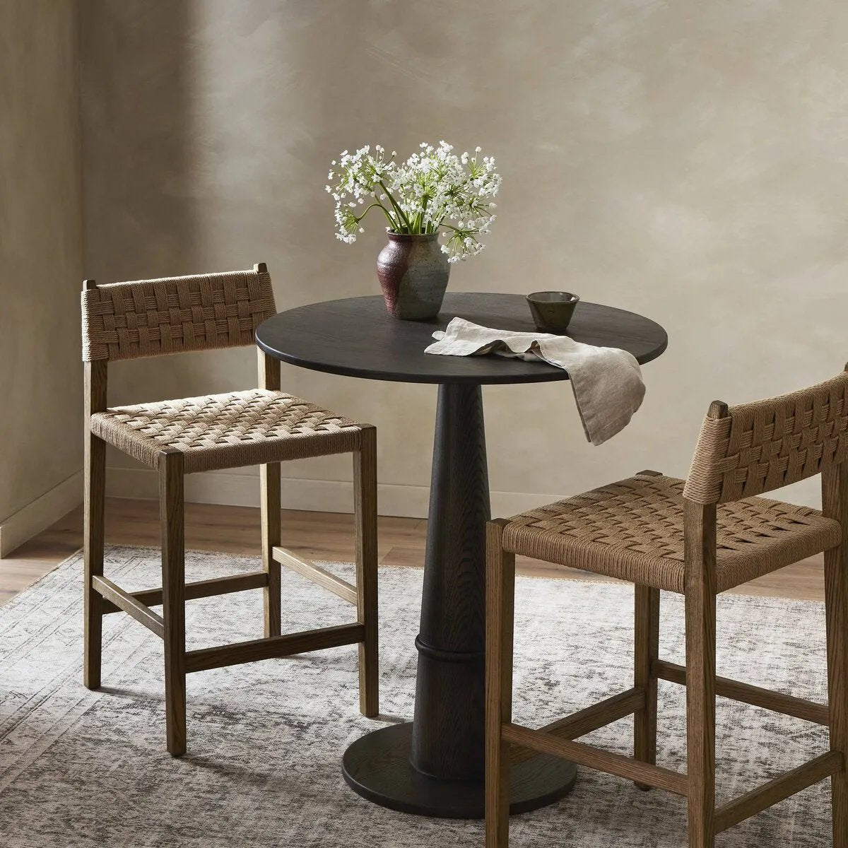 Featuring Hamlin Double Twisted Paper Cord Counter Stool by Four Hands at Amethyst Home. Expertly crafted using double twisted paper cord, the Hamlin Counter Stool is not only visually stunning but also incredibly durable. Its unique construction offers a 20% higher weight capacity compared to traditional stools.
Overall Dimensions: 20.0" L x 19.75 " W x 37.25. Amethyst Home provides interior design, new home construction design consulting, vintage area rugs, and lighting in the Dallas metro area.