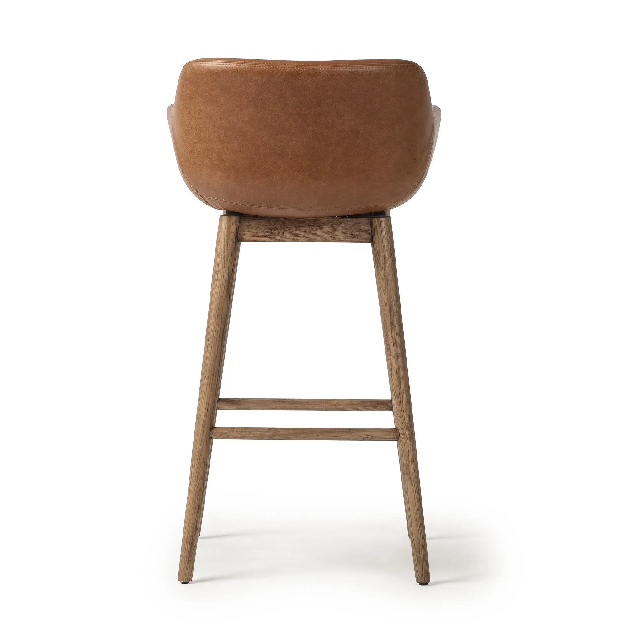 Featuring Hannah Sonoma Chestnut  Swivel Bar + Counter Stool by Four Hands at Amethyst Home. A midcentury-inspired counter stool gets refreshed with a modern memory swivel and chestnut top-grain leather. Slim, tapered oak legs balance a curved seat.BarOverall Dimensions: 21.75"w x 20.50"d x 40.75"hWeight: 23.81 lbsCounterOverall Dimensions: 21.75"w x 20.50"d x. Amethyst Home provides interior design, new home construction design consulting, vintage area rugs, and lighting in the Austin metro area.
