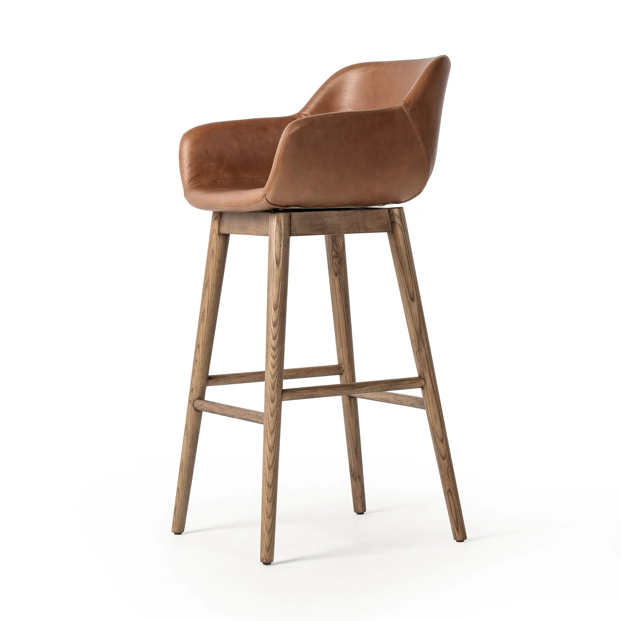 Featuring Hannah Sonoma Chestnut  Swivel Bar + Counter Stool by Four Hands at Amethyst Home. A midcentury-inspired counter stool gets refreshed with a modern memory swivel and chestnut top-grain leather. Slim, tapered oak legs balance a curved seat.BarOverall Dimensions: 21.75"w x 20.50"d x 40.75"hWeight: 23.81 lbsCounterOverall Dimensions: 21.75"w x 20.50"d x. Amethyst Home provides interior design, new home construction design consulting, vintage area rugs, and lighting in the Boston metro area.