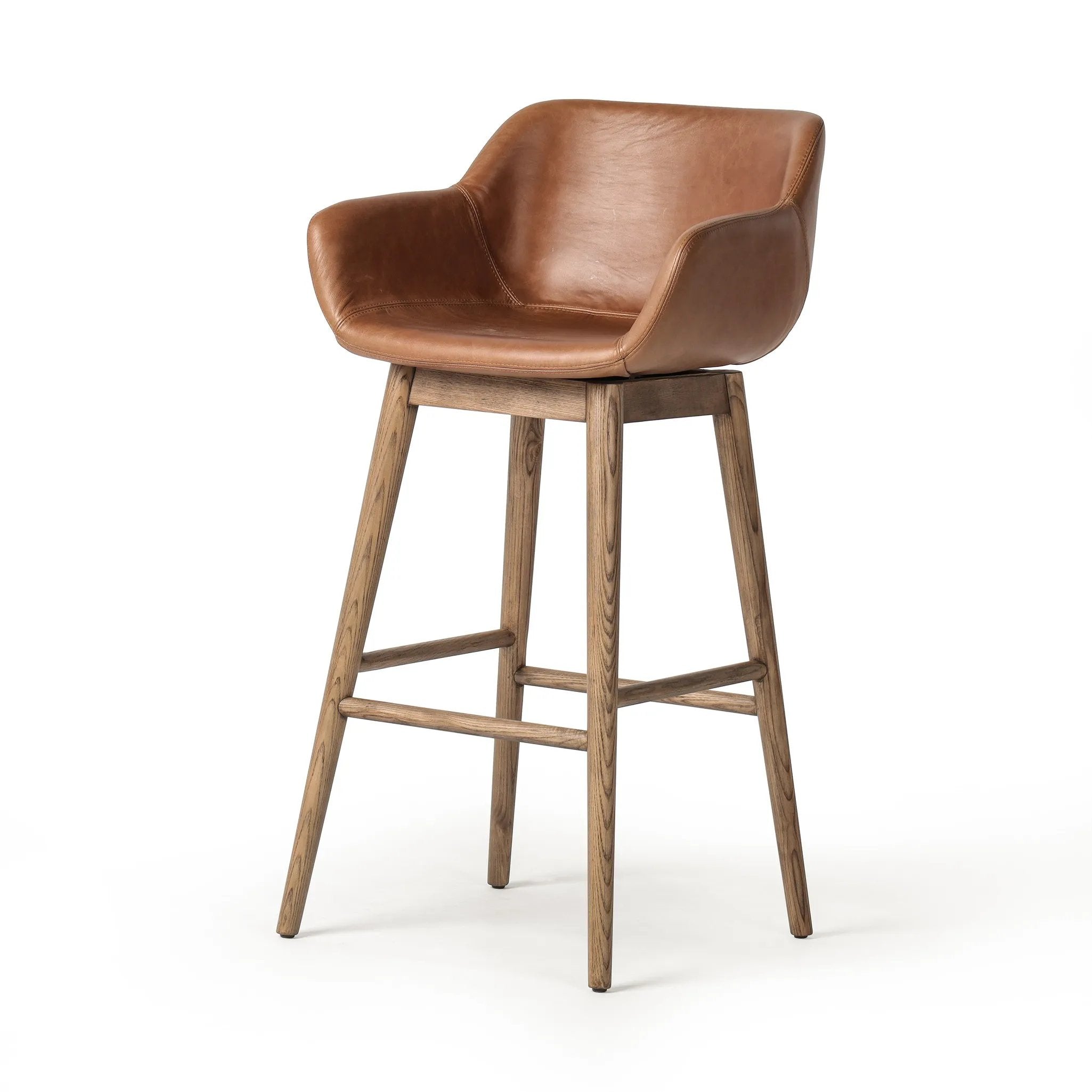 Featuring Hannah Sonoma Chestnut  Swivel Bar + Counter Stool by Four Hands at Amethyst Home. A midcentury-inspired counter stool gets refreshed with a modern memory swivel and chestnut top-grain leather. Slim, tapered oak legs balance a curved seat.BarOverall Dimensions: 21.75"w x 20.50"d x 40.75"hWeight: 23.81 lbsCounterOverall Dimensions: 21.75"w x 20.50". Amethyst Home provides interior design, new home construction design consulting, vintage area rugs, and lighting in the Park City metro area.