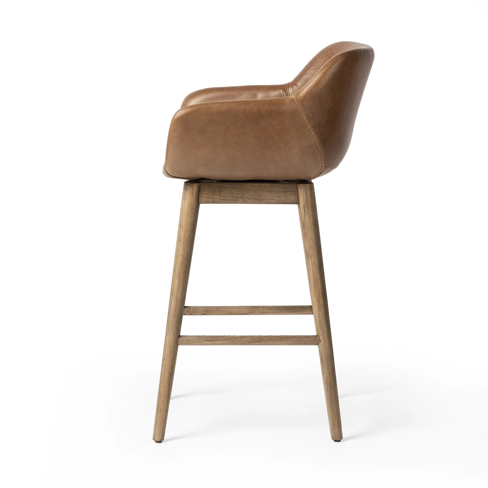 Featuring Hannah Sonoma Chestnut Swivel Counter Stool by Four Hands at Amethyst Home. Experience the ultimate in comfort and style with the Hannah Sonoma Chestnut Swivel Bar + Counter Stool. Featuring a durable and sleek design, this stool offers maximum support and functionality. With its smooth swivel motion, you can easily reach for things around you, m. Amethyst Home provides interior design, new home construction design consulting, vintage area rugs, and lighting in the Scottsdale metro area.
