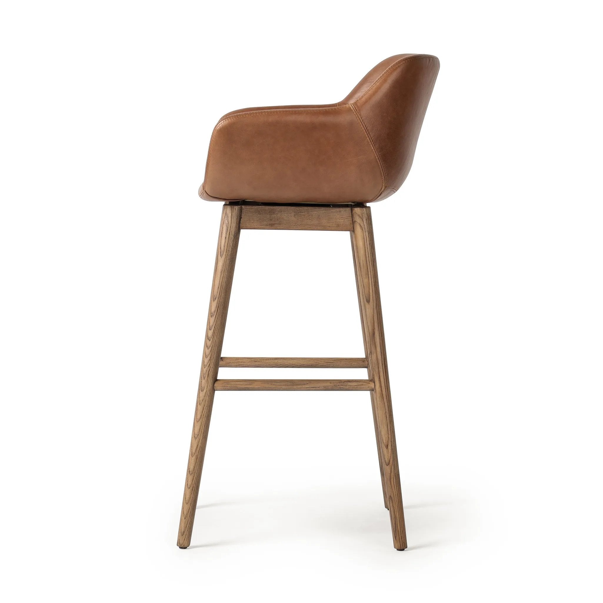 Featuring Hannah Sonoma Chestnut  Swivel Bar + Counter Stool by Four Hands at Amethyst Home. A midcentury-inspired counter stool gets refreshed with a modern memory swivel and chestnut top-grain leather. Slim, tapered oak legs balance a curved seat.BarOverall Dimensions: 21.75"w x 20.50"d x 40.75"hWeight: 23.81 lbsCounterOverall Dimensions: 21.75"w x 20.50. Amethyst Home provides interior design, new home construction design consulting, vintage area rugs, and lighting in the Washington metro area.