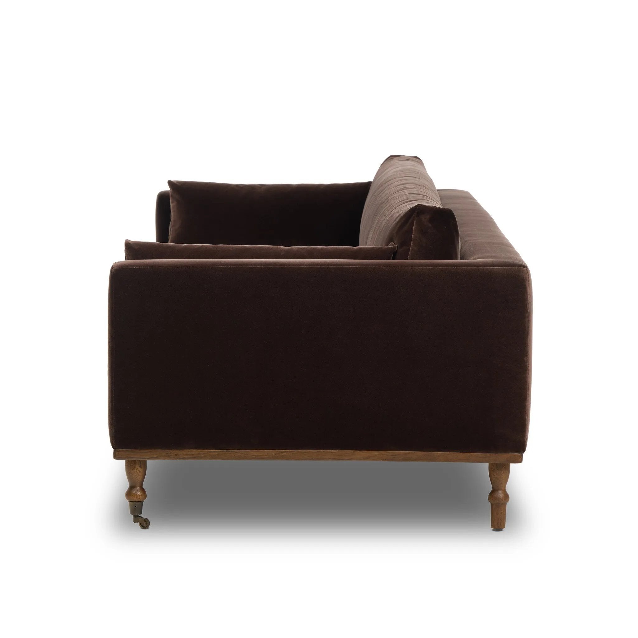 Mid-century modern with a dash of vintage detail, this bench-style sofa makes a statement. With traditional details like turned oak legs and brass casters, this low-profile sofa features an elongated bench seat for an inviting sit. Velvety chocolate-brown upholstery finishes a knife-edge back and boxed arm cushions Amethyst Home provides interior design, new home construction design consulting, vintage area rugs, and lighting in the Alpharetta metro area.