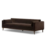 Mid-century modern with a dash of vintage detail, this bench-style sofa makes a statement. With traditional details like turned oak legs and brass casters, this low-profile sofa features an elongated bench seat for an inviting sit. Velvety chocolate-brown upholstery finishes a knife-edge back and boxed arm cushions Amethyst Home provides interior design, new home construction design consulting, vintage area rugs, and lighting in the Laguna Beach metro area.