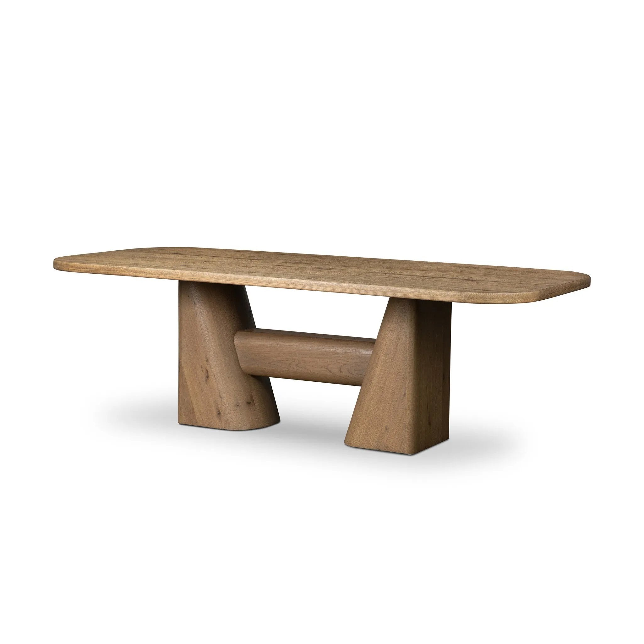 This modern take on the traditional trestle table features two angular bases, mirrored and united by softened square center beam. Dramatically angled legs pull the eye toward beautifully curved detailing. Crafted of oak with a light, natural finish. Amethyst Home provides interior design, new home construction design consulting, vintage area rugs, and lighting in the Kansas City metro area.