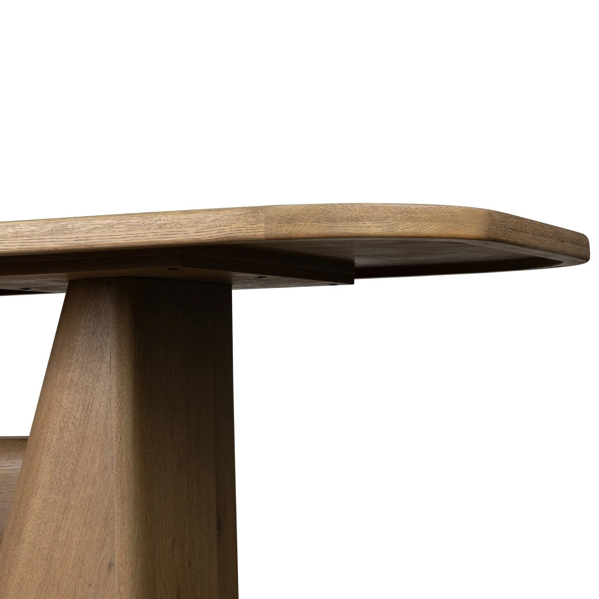 This modern take on the traditional trestle table features two angular bases, mirrored and united by softened square center beam. Dramatically angled legs pull the eye toward beautifully curved detailing. Crafted of oak with a light, natural finish. Amethyst Home provides interior design, new home construction design consulting, vintage area rugs, and lighting in the Monterey metro area.