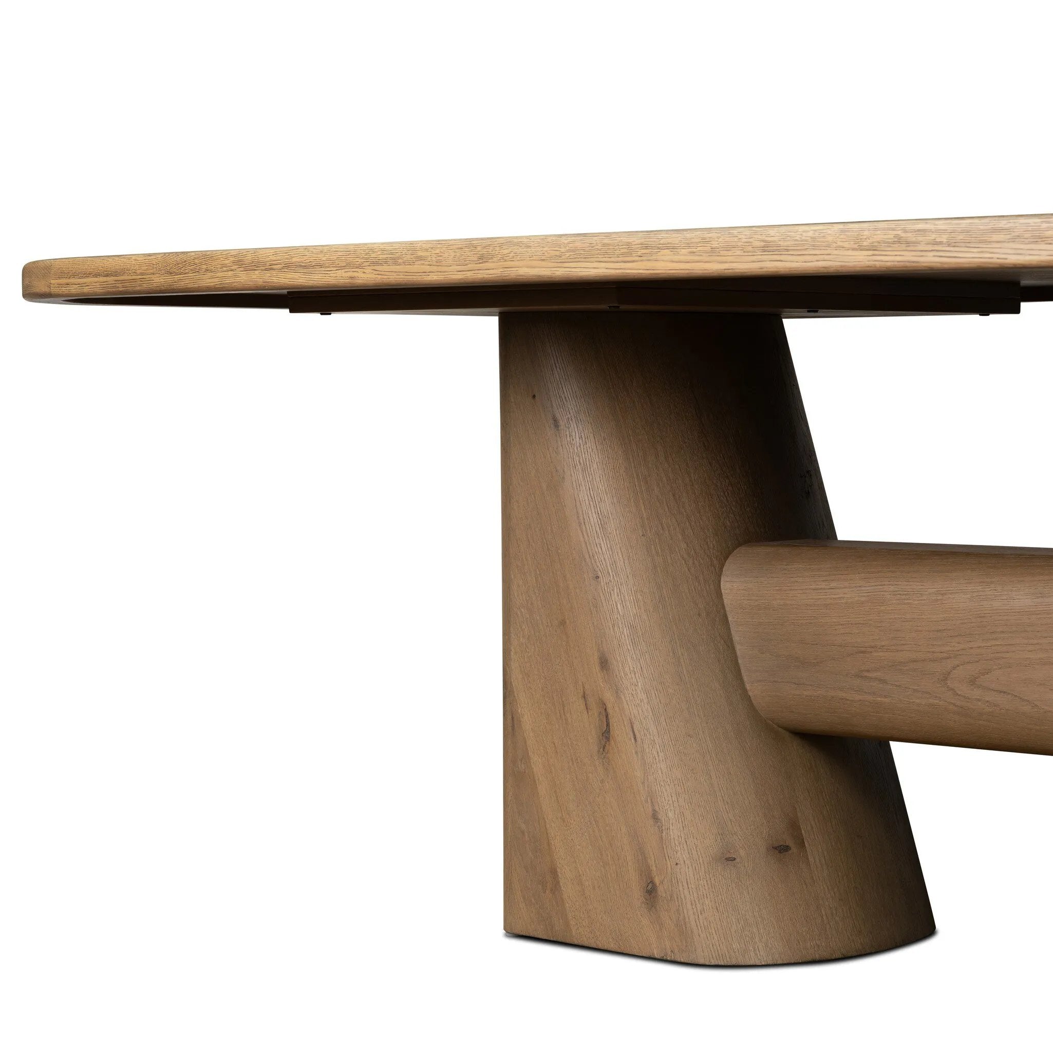 This modern take on the traditional trestle table features two angular bases, mirrored and united by softened square center beam. Dramatically angled legs pull the eye toward beautifully curved detailing. Crafted of oak with a light, natural finish. Amethyst Home provides interior design, new home construction design consulting, vintage area rugs, and lighting in the Park City metro area.