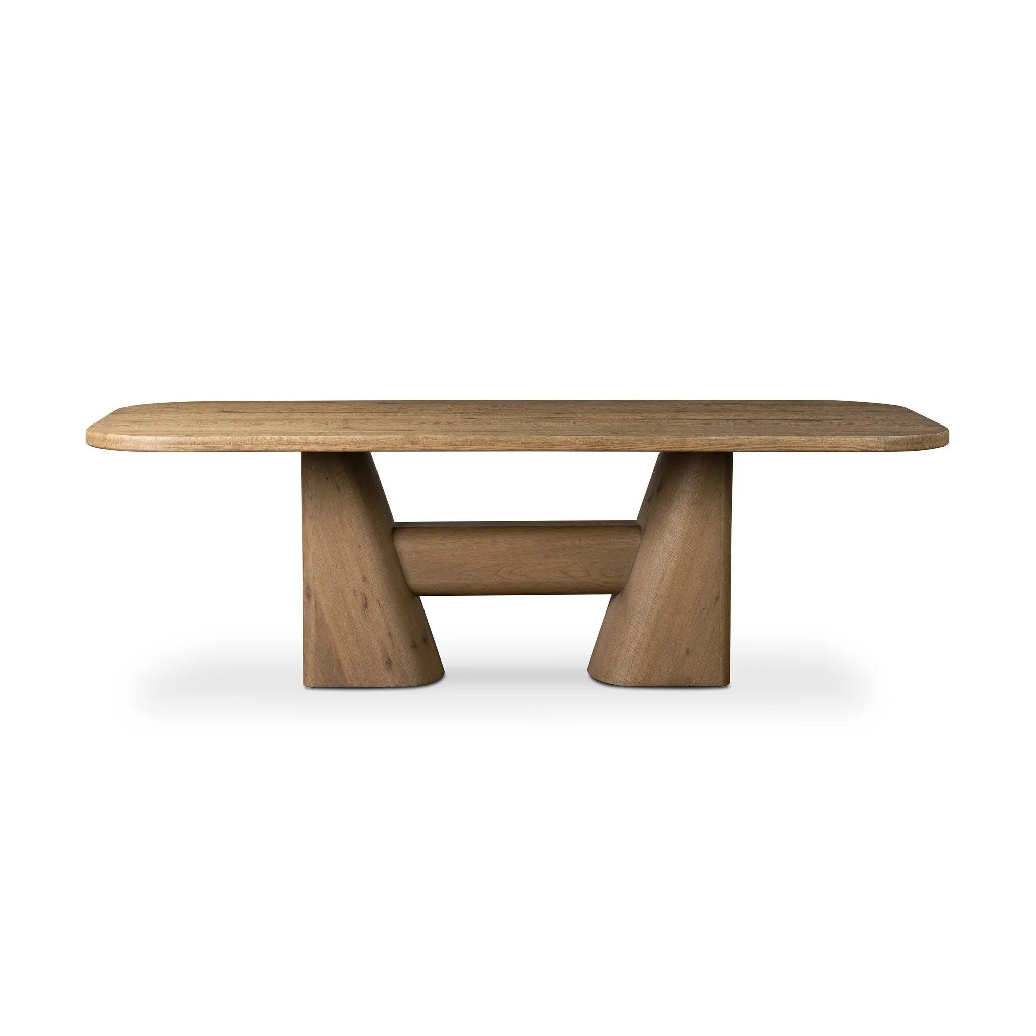 This modern take on the traditional trestle table features two angular bases, mirrored and united by softened square center beam. Dramatically angled legs pull the eye toward beautifully curved detailing. Crafted of oak with a light, natural finish. Amethyst Home provides interior design, new home construction design consulting, vintage area rugs, and lighting in the Salt Lake City metro area.