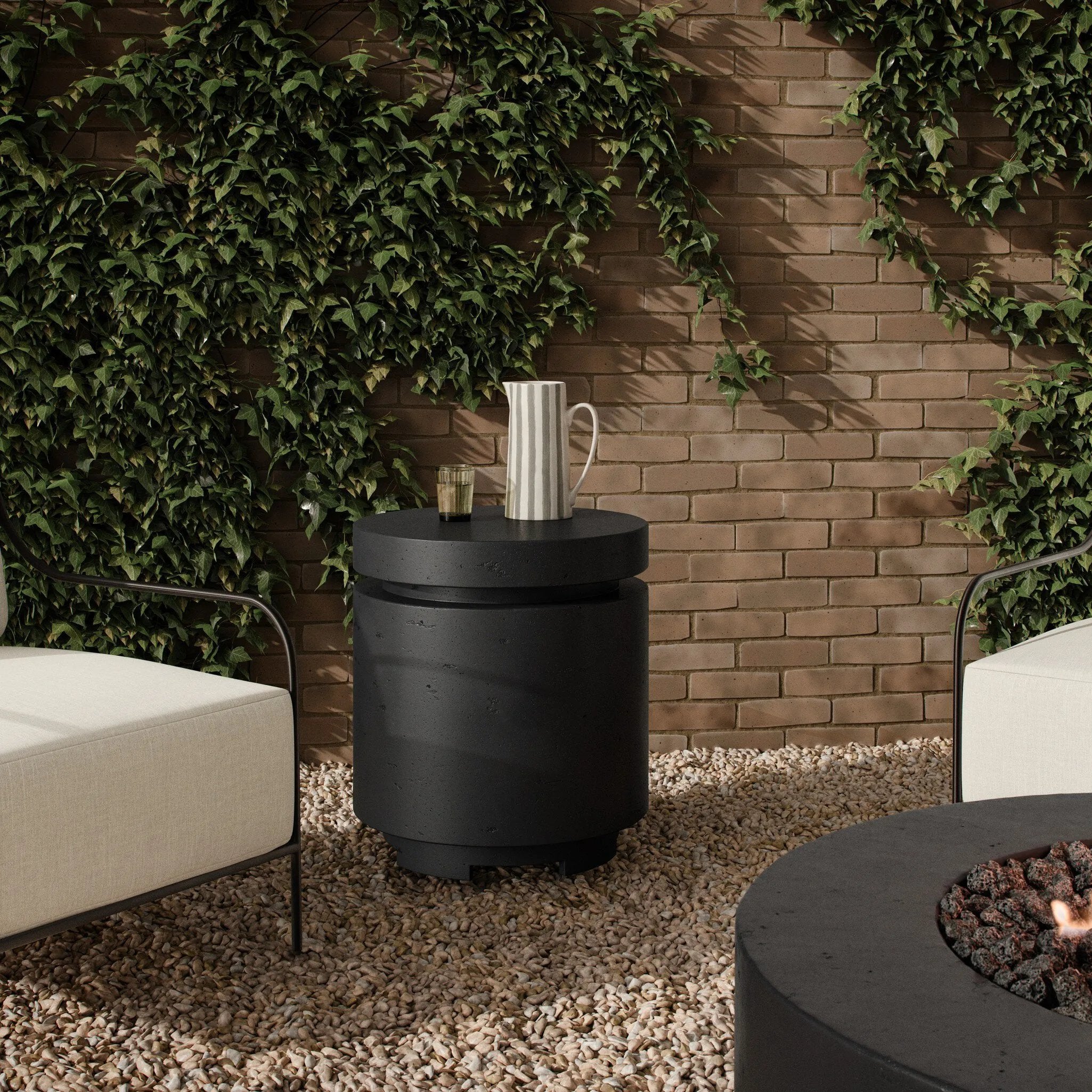 This outdoor propane tank enclosure pairs with fire tables for a clean, seamless look. Made from glass-reinforced concrete, each piece is naturally finished with deep tones of charcoal. It can act as an end table with its lid on, and has cutouts at the base for hose attachments. Cover or store indoors during inclement weather and when not in use. Amethyst Home provides interior design, new home construction design consulting, vintage area rugs, and lighting in the Omaha metro area.