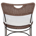 A light, airy take on the traditional bistro shape. This outdoor dining chair features exaggerated splayed legs and a curved X-shaped stretcher, with a handle detail cut out of the woven seat back. Finished with a seat cushion. Cover or store indoors during inclement weather and when not in use. Amethyst Home provides interior design, new home construction design consulting, vintage area rugs, and lighting in the Charlotte metro area.