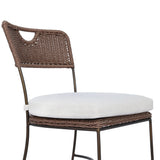 A light, airy take on the traditional bistro shape. This outdoor dining chair features exaggerated splayed legs and a curved X-shaped stretcher, with a handle detail cut out of the woven seat back. Finished with a seat cushion. Cover or store indoors during inclement weather and when not in use. Amethyst Home provides interior design, new home construction design consulting, vintage area rugs, and lighting in the Dallas metro area.