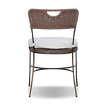 A light, airy take on the traditional bistro shape. This outdoor dining chair features exaggerated splayed legs and a curved X-shaped stretcher, with a handle detail cut out of the woven seat back. Finished with a seat cushion. Cover or store indoors during inclement weather and when not in use. Amethyst Home provides interior design, new home construction design consulting, vintage area rugs, and lighting in the Omaha metro area.