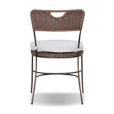 A light, airy take on the traditional bistro shape. This outdoor dining chair features exaggerated splayed legs and a curved X-shaped stretcher, with a handle detail cut out of the woven seat back. Finished with a seat cushion. Cover or store indoors during inclement weather and when not in use. Amethyst Home provides interior design, new home construction design consulting, vintage area rugs, and lighting in the Omaha metro area.