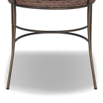A light, airy take on the traditional bistro shape. This outdoor dining chair features exaggerated splayed legs and a curved X-shaped stretcher, with a handle detail cut out of the woven seat back. Finished with a seat cushion. Cover or store indoors during inclement weather and when not in use. Amethyst Home provides interior design, new home construction design consulting, vintage area rugs, and lighting in the Park City metro area.