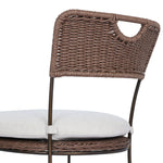 A light, airy take on the traditional bistro shape. This outdoor dining chair features exaggerated splayed legs and a curved X-shaped stretcher, with a handle detail cut out of the woven seat back. Finished with a seat cushion. Cover or store indoors during inclement weather and when not in use. Amethyst Home provides interior design, new home construction design consulting, vintage area rugs, and lighting in the Washington metro area.