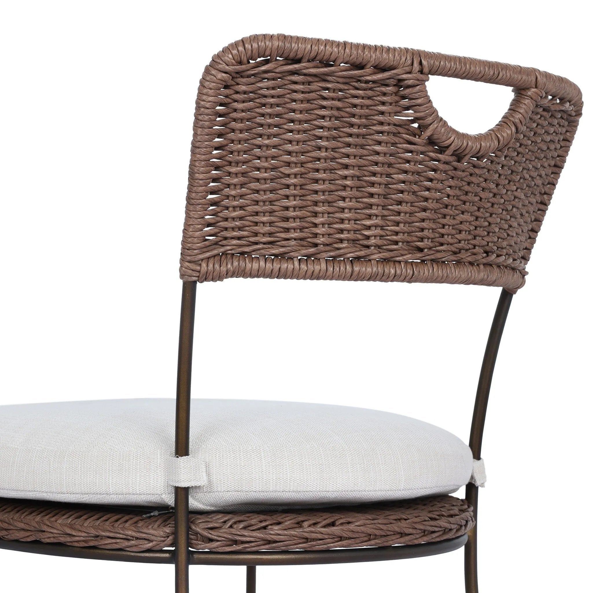 A light, airy take on the traditional bistro shape. This outdoor dining chair features exaggerated splayed legs and a curved X-shaped stretcher, with a handle detail cut out of the woven seat back. Finished with a seat cushion. Cover or store indoors during inclement weather and when not in use. Amethyst Home provides interior design, new home construction design consulting, vintage area rugs, and lighting in the Washington metro area.
