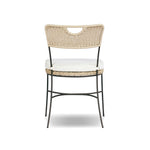 A light, airy take on the traditional bistro shape. This outdoor dining chair features exaggerated splayed legs and a curved X-shaped stretcher, with a handle detail cut out of the woven seat back. Finished with a seat cushion. Cover or store indoors during inclement weather and when not in use. Amethyst Home provides interior design, new home construction design consulting, vintage area rugs, and lighting in the Des Moines metro area.