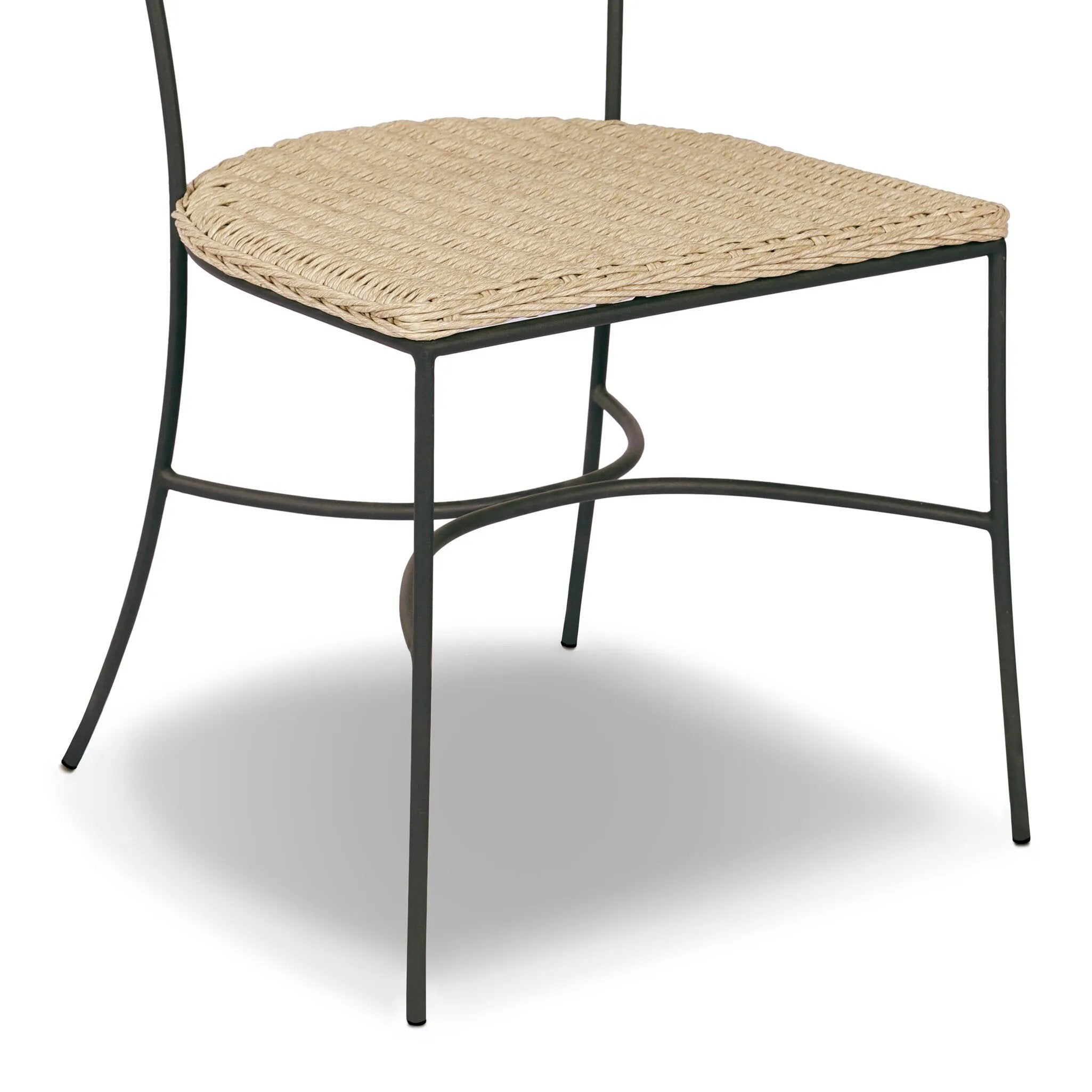 A light, airy take on the traditional bistro shape. This outdoor dining chair features exaggerated splayed legs and a curved X-shaped stretcher, with a handle detail cut out of the woven seat back. Finished with a seat cushion. Cover or store indoors during inclement weather and when not in use. Amethyst Home provides interior design, new home construction design consulting, vintage area rugs, and lighting in the Monterey metro area.
