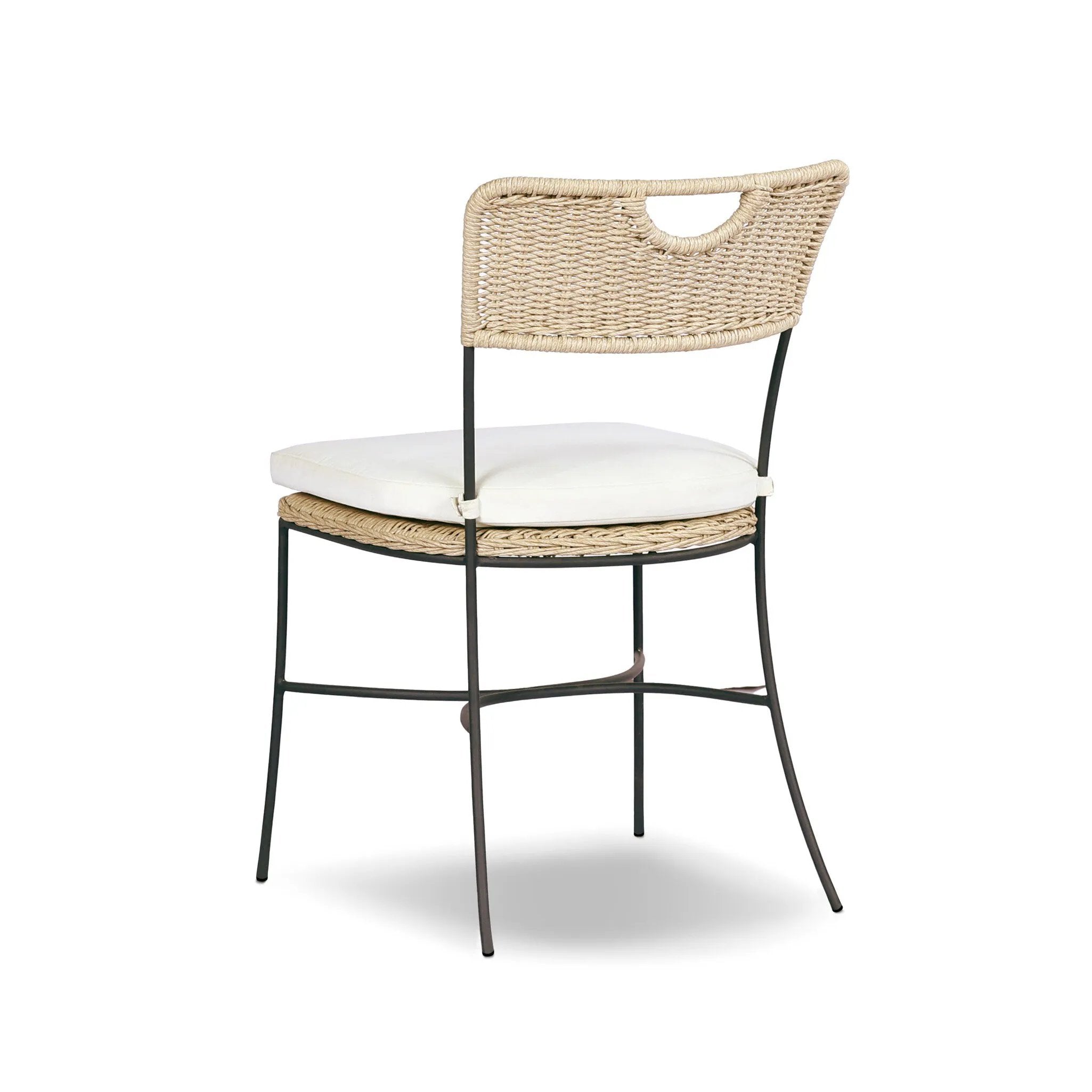 A light, airy take on the traditional bistro shape. This outdoor dining chair features exaggerated splayed legs and a curved X-shaped stretcher, with a handle detail cut out of the woven seat back. Finished with a seat cushion. Cover or store indoors during inclement weather and when not in use. Amethyst Home provides interior design, new home construction design consulting, vintage area rugs, and lighting in the Scottsdale metro area.
