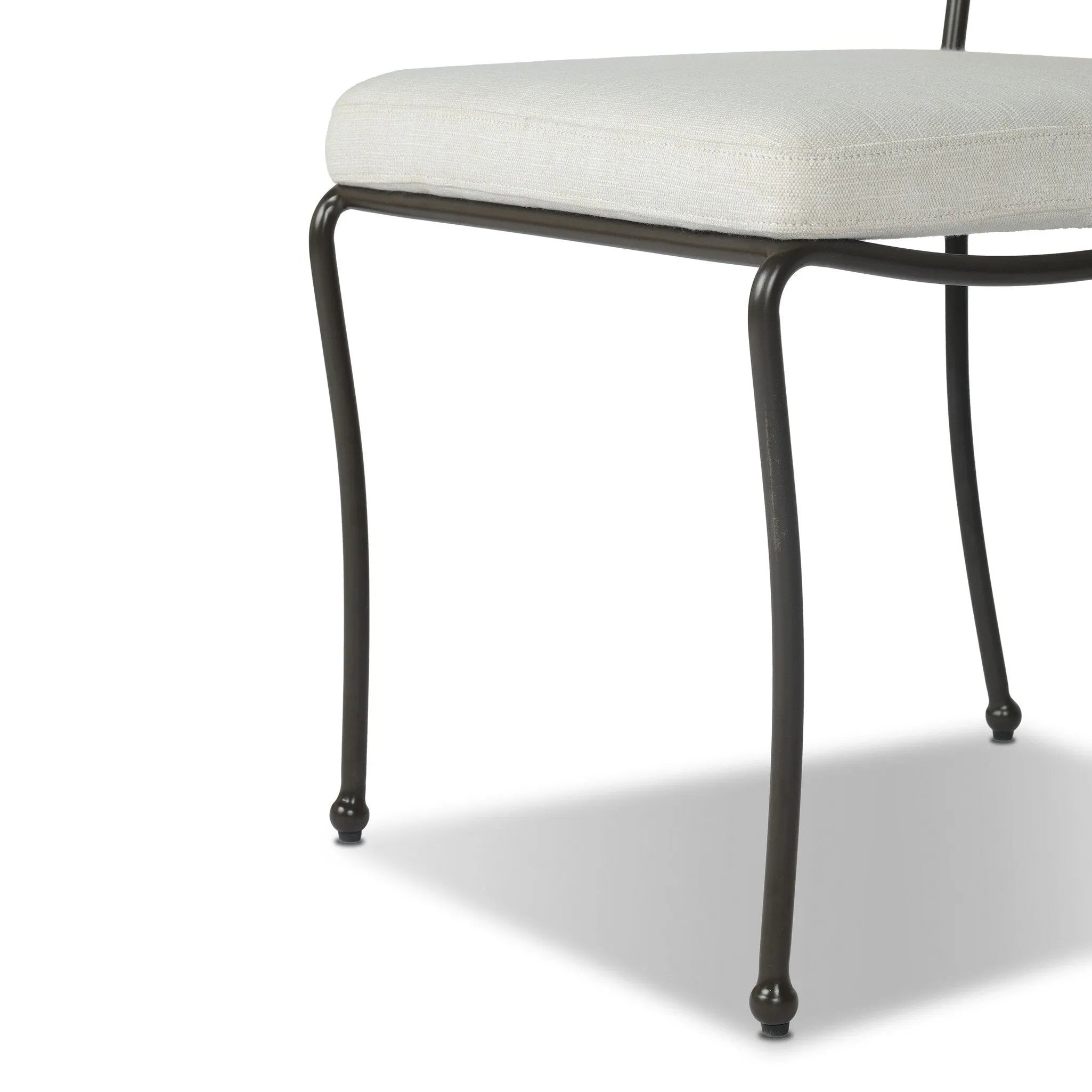 Inspired by Art Deco designs, this outdoor dining chair introduces a sense of movement to a classic silhouette. Subtly curved metal framing, a woven back and upholstered seat cushion craft a thoughtful mix of materials. Cover or store inside during inclement weather and when not in use. Amethyst Home provides interior design, new home construction design consulting, vintage area rugs, and lighting in the Laguna Beach metro area.