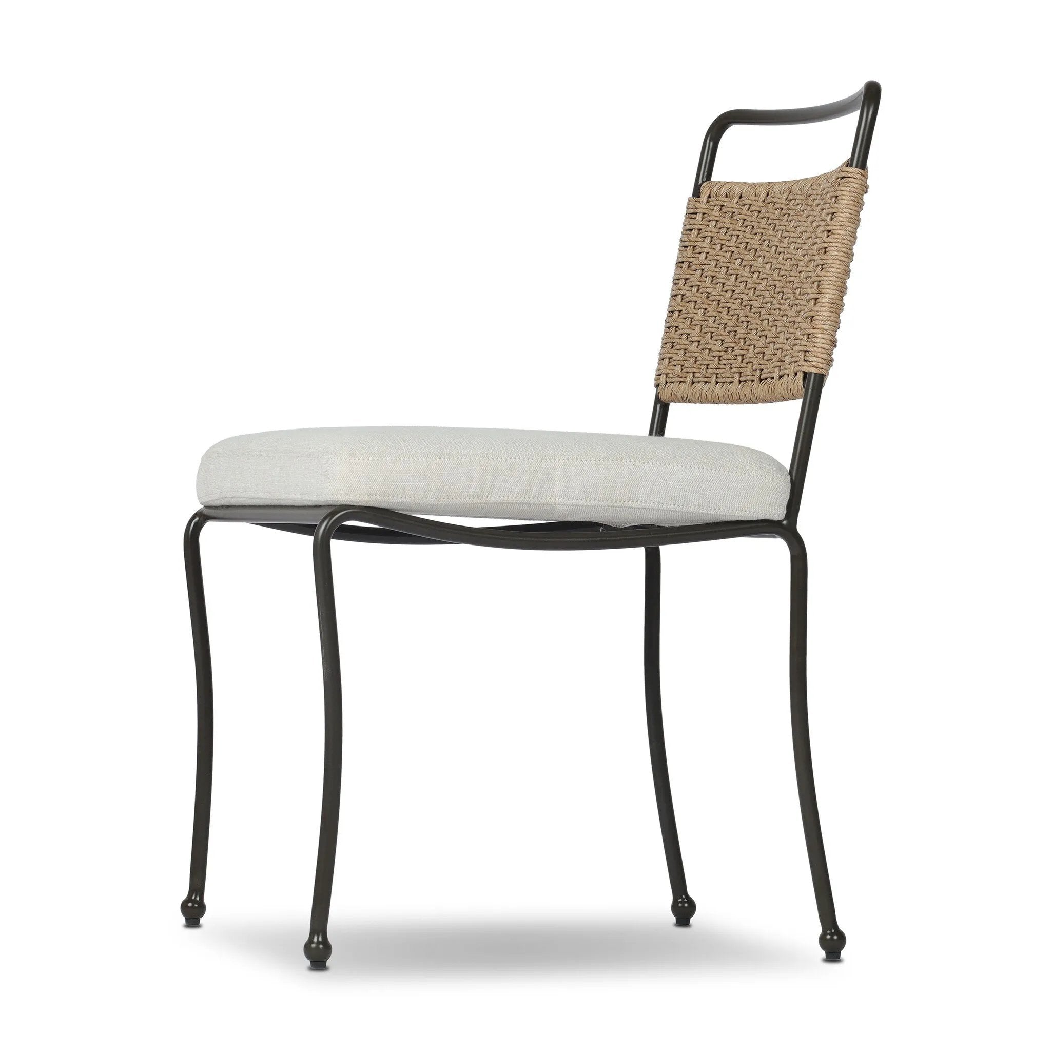 Inspired by Art Deco designs, this outdoor dining chair introduces a sense of movement to a classic silhouette. Subtly curved metal framing, a woven back and upholstered seat cushion craft a thoughtful mix of materials. Cover or store inside during inclement weather and when not in use. Amethyst Home provides interior design, new home construction design consulting, vintage area rugs, and lighting in the Park City metro area.