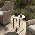 Inspired by Art Deco designs, this outdoor end table introduces a sense of movement to a classic silhouette. Graceful, flowing lines on the base pair with a white marble top for a classic black-and-white look. Cover or store inside during inclement weather and when not in use. Amethyst Home provides interior design, new home construction design consulting, vintage area rugs, and lighting in the Salt Lake City metro area.