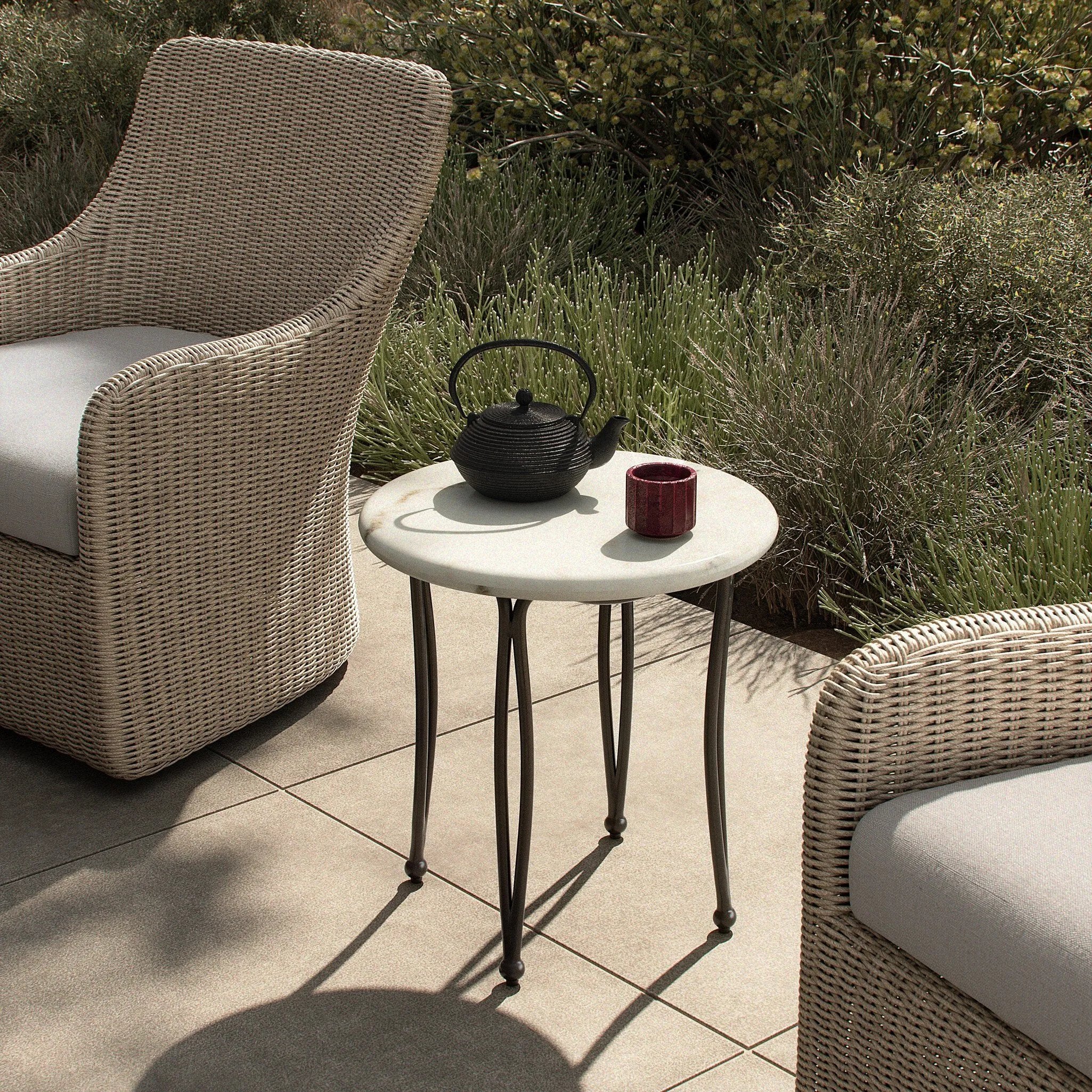 Inspired by Art Deco designs, this outdoor end table introduces a sense of movement to a classic silhouette. Graceful, flowing lines on the base pair with a white marble top for a classic black-and-white look. Cover or store inside during inclement weather and when not in use. Amethyst Home provides interior design, new home construction design consulting, vintage area rugs, and lighting in the Salt Lake City metro area.
