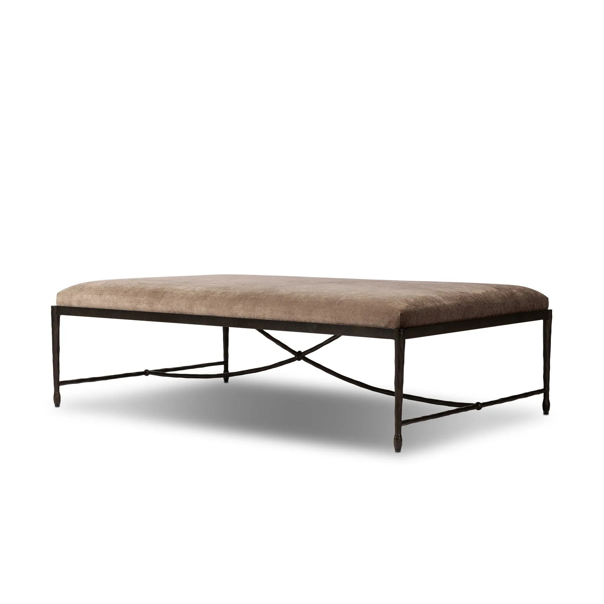 This French Industrialist-inspired cocktail ottoman features a curved stretcher base of bronzed hammered iron and a velvety seat in a versatile earth tone. Style with a sofa or sectional to create an extra surface in your living space, or for bonus seating. Amethyst Home provides interior design, new home construction design consulting, vintage area rugs, and lighting in the Laguna Beach metro area.