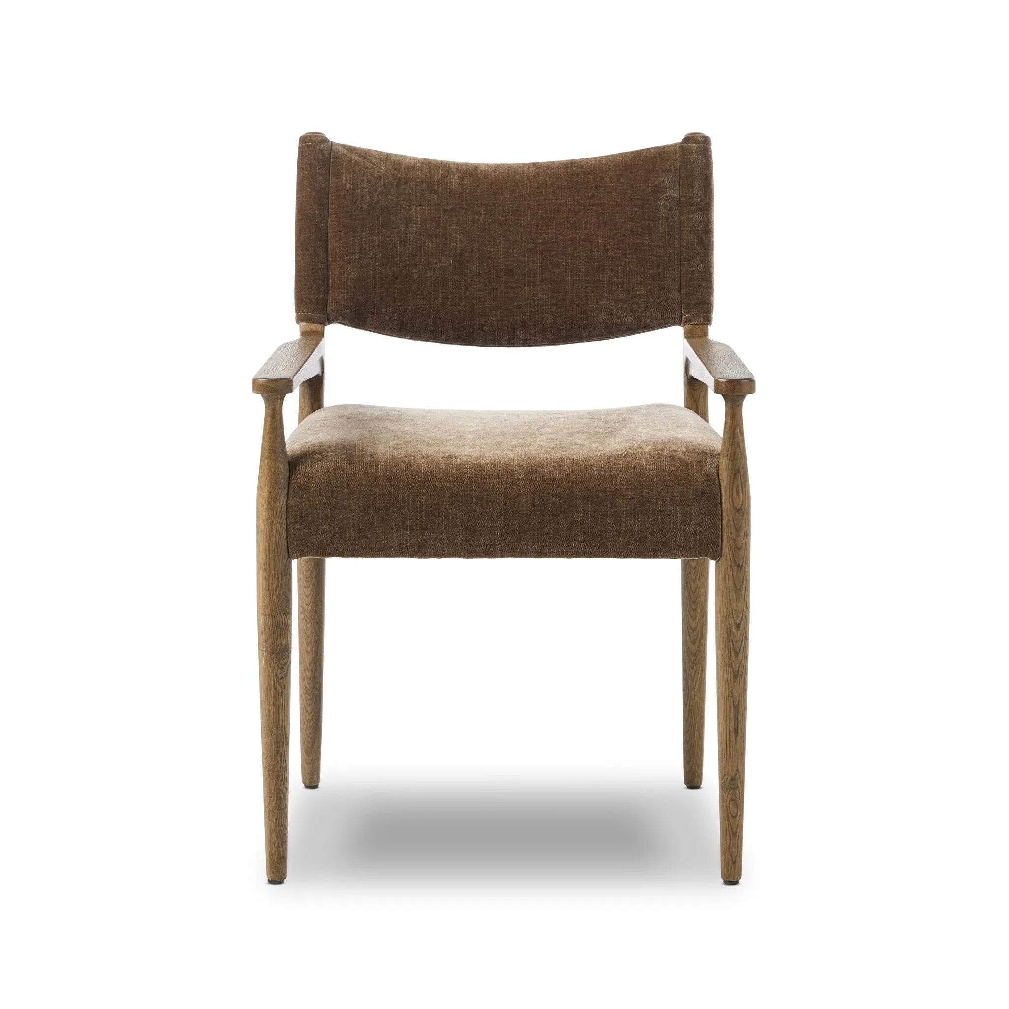 A midcentury-inspired piece brought to modern speed. A supportive, sling-style back and seat cushion are upholstered in a soft, velvety fabric, with toasted oak arms prime for the head of the table Amethyst Home provides interior design, new home construction design consulting, vintage area rugs, and lighting in the Boston metro area.