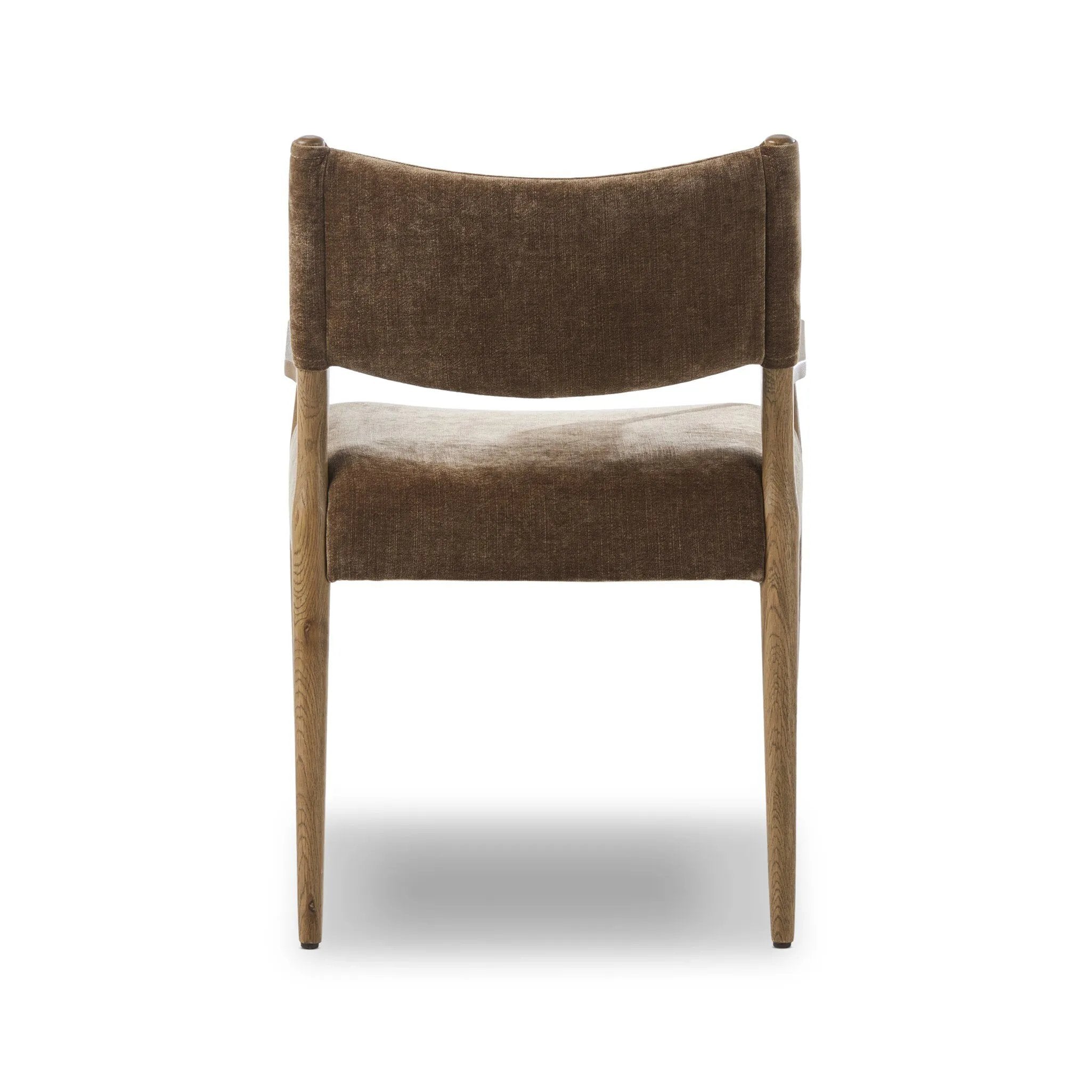 A midcentury-inspired piece brought to modern speed. A supportive, sling-style back and seat cushion are upholstered in a soft, velvety fabric, with toasted oak arms prime for the head of the table Amethyst Home provides interior design, new home construction design consulting, vintage area rugs, and lighting in the Charlotte metro area.