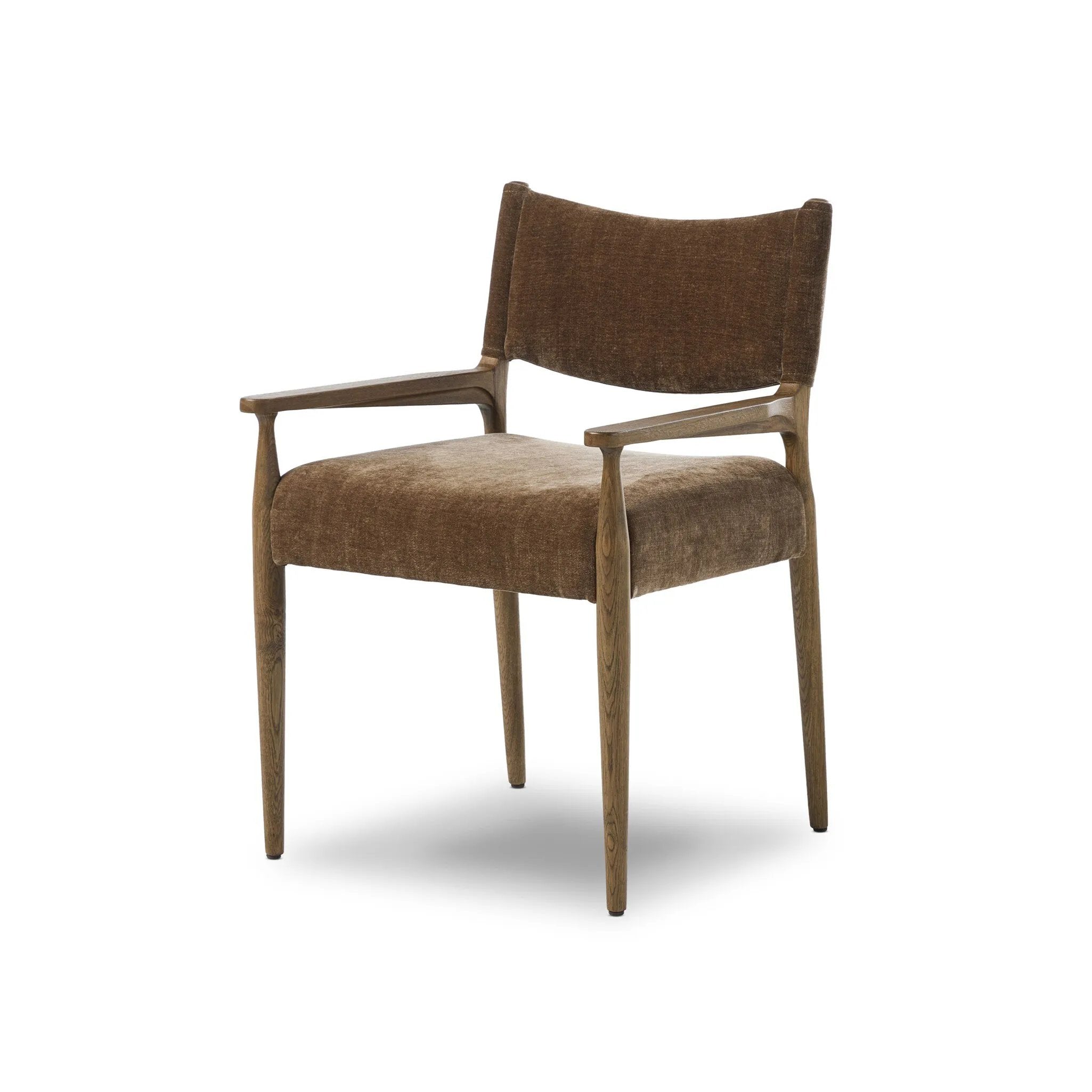 A midcentury-inspired piece brought to modern speed. A supportive, sling-style back and seat cushion are upholstered in a soft, velvety fabric, with toasted oak arms prime for the head of the table Amethyst Home provides interior design, new home construction design consulting, vintage area rugs, and lighting in the Monterey metro area.