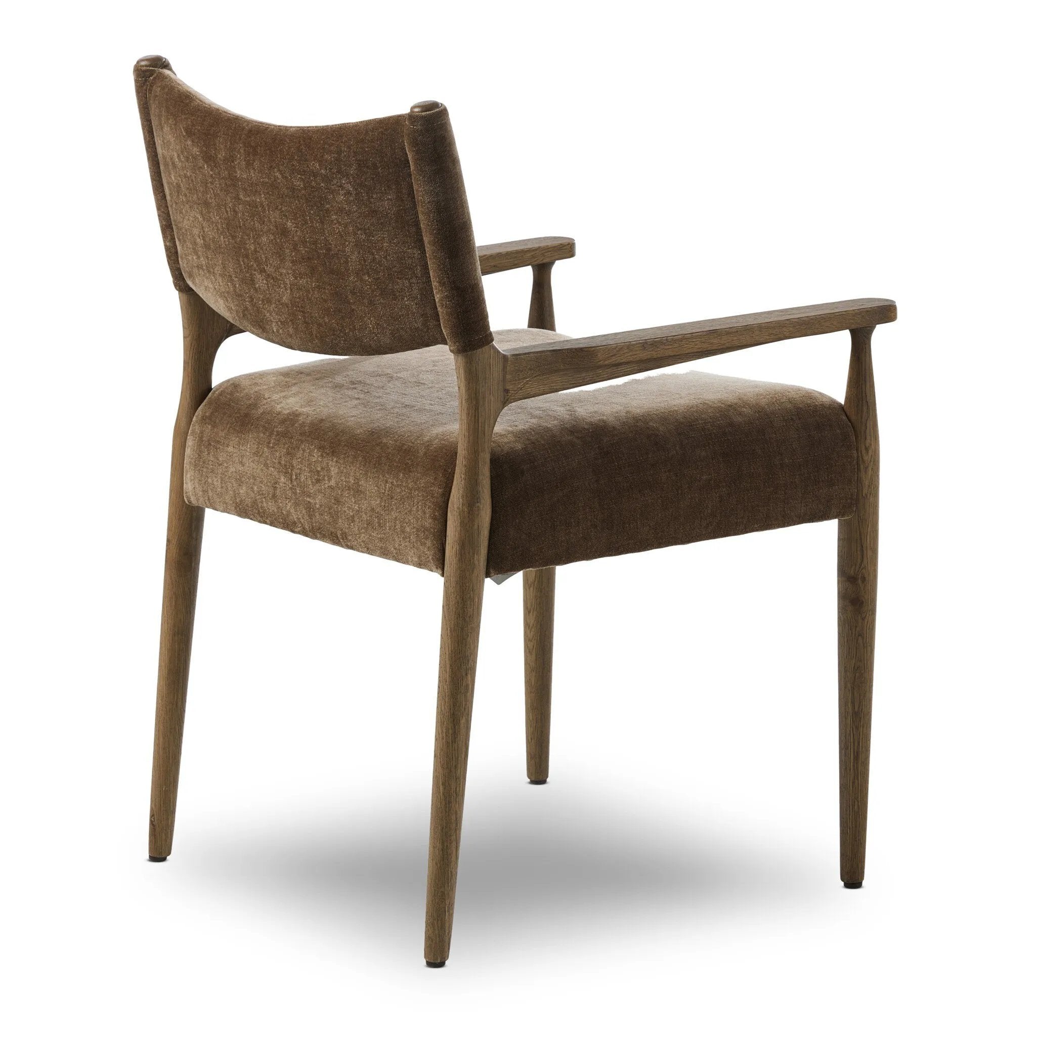 A midcentury-inspired piece brought to modern speed. A supportive, sling-style back and seat cushion are upholstered in a soft, velvety fabric, with toasted oak arms prime for the head of the table Amethyst Home provides interior design, new home construction design consulting, vintage area rugs, and lighting in the Newport Beach metro area.