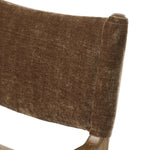 A midcentury-inspired piece brought to modern speed. A supportive, sling-style back and seat cushion are upholstered in a soft, velvety fabric, with toasted oak arms prime for the head of the table Amethyst Home provides interior design, new home construction design consulting, vintage area rugs, and lighting in the Washington metro area.